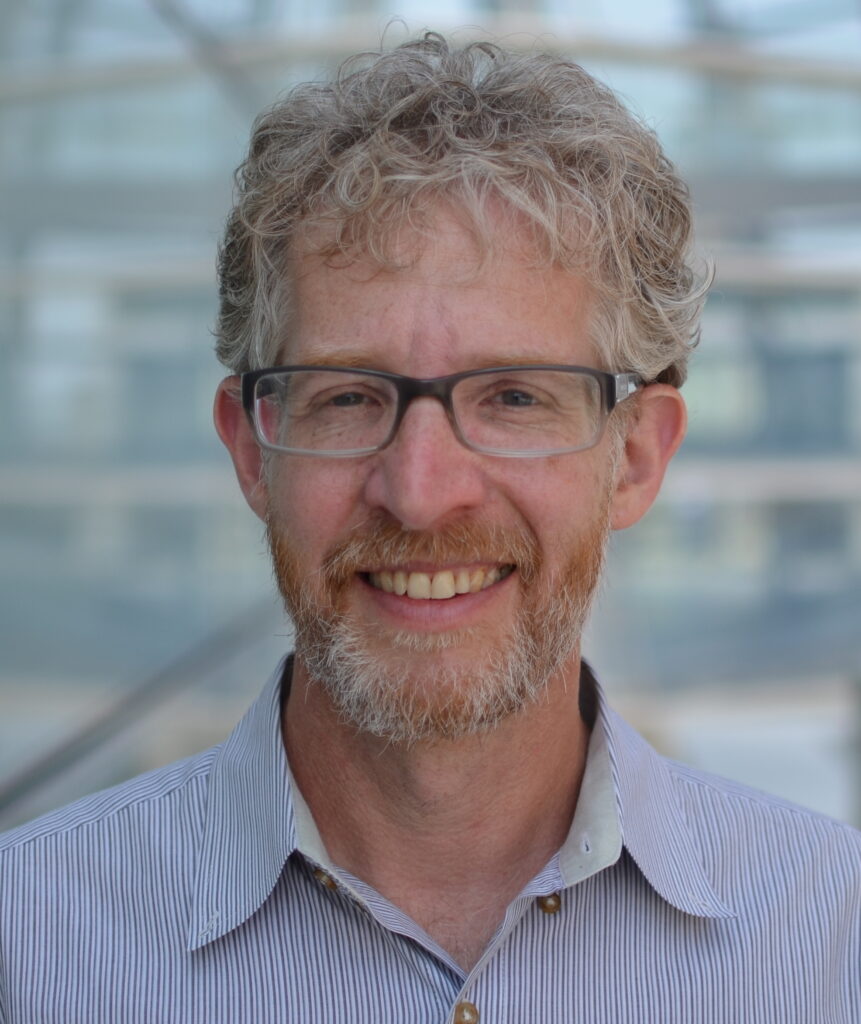 Scott Rosenfeld with glasses smiling