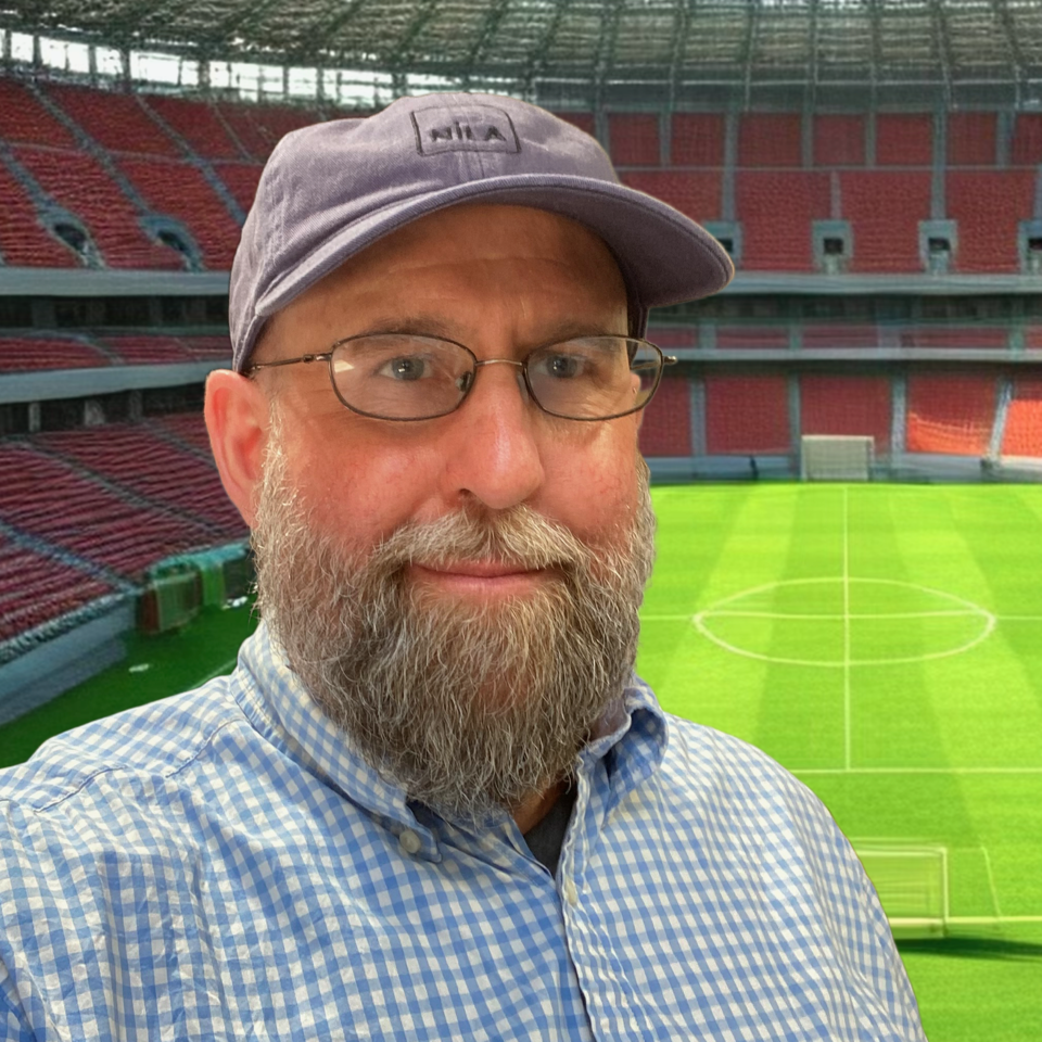 Jim Sanfilippo's photograph with a soccer court on the background
