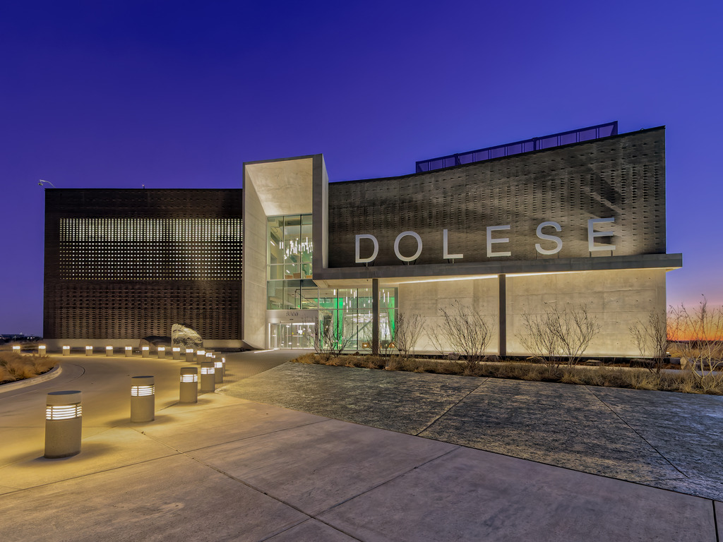 A Gem Shines Through | Dolese Bros headquarters | Filtered views beyond the façade through the entry portal, past the pendant cluster to the colorful Gem inside portray a company that is serious about its business but determined to have fun