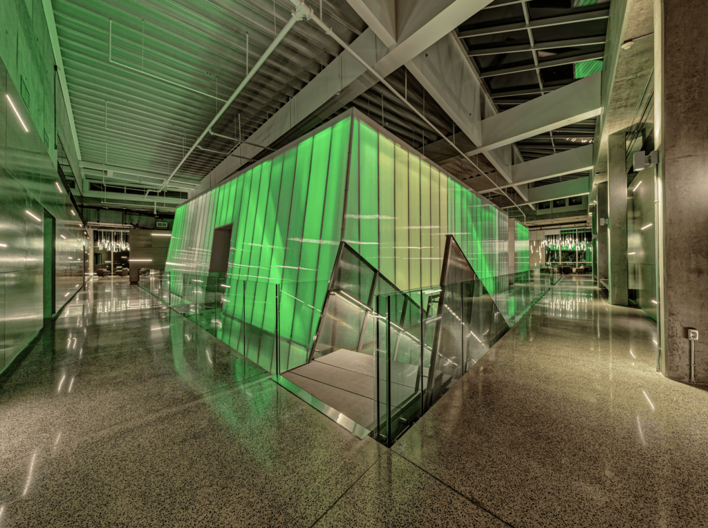 A Gem Shines Through | Dolese Bros headquarters | The top floor of The Gem features soft seating areas anchored by custom/modified pendants at the end of each axial view and column-mounted luminaires in the circulation zone