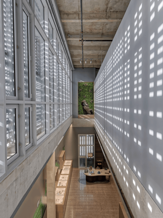 A Gem Shines Through | Dolese Bros headquarters | The Dolese Museum’s dramatic shadows transform after dark with the help of an immense window shade that lowers at sunset to create a luminous backdrop, visually “popping” the brick screen wall openings when viewed from the exterior