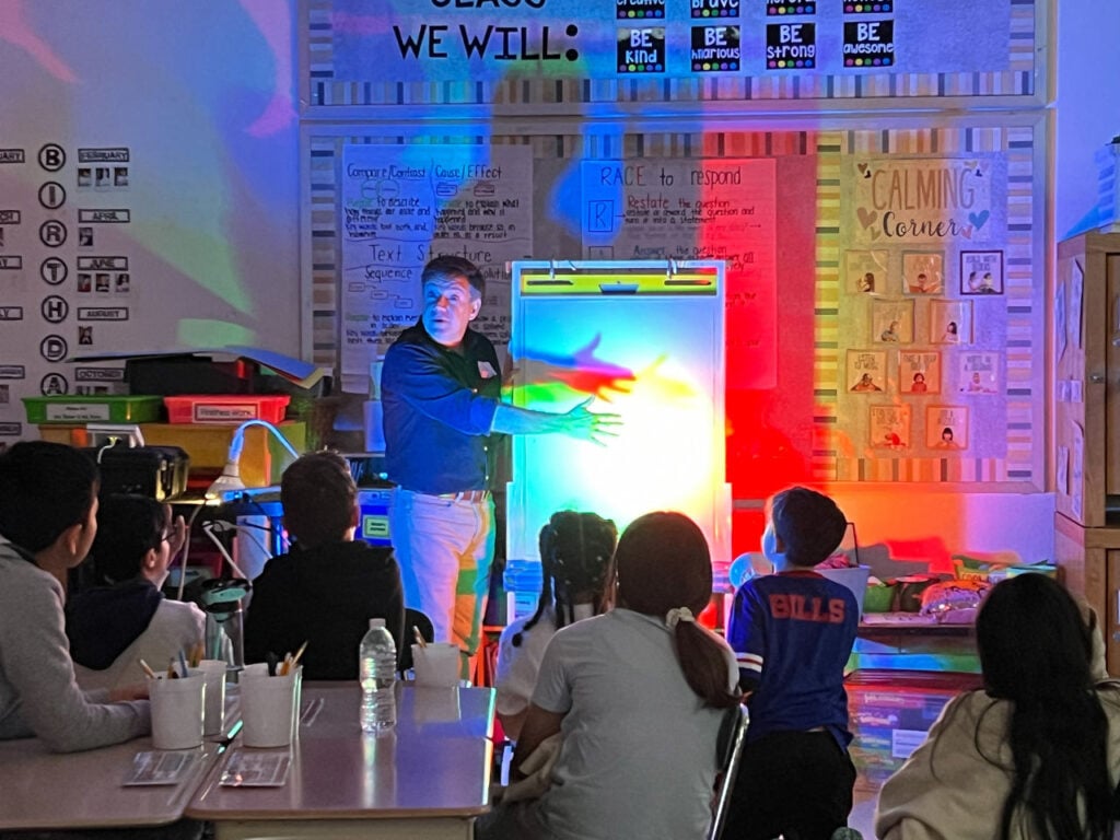 Sightlines | This Is the Way: Bringing the art and science of illumination to children | Jason Livingston demonstrates color mixing and shadow fill. Photo courtesy of Equity in Lighting.