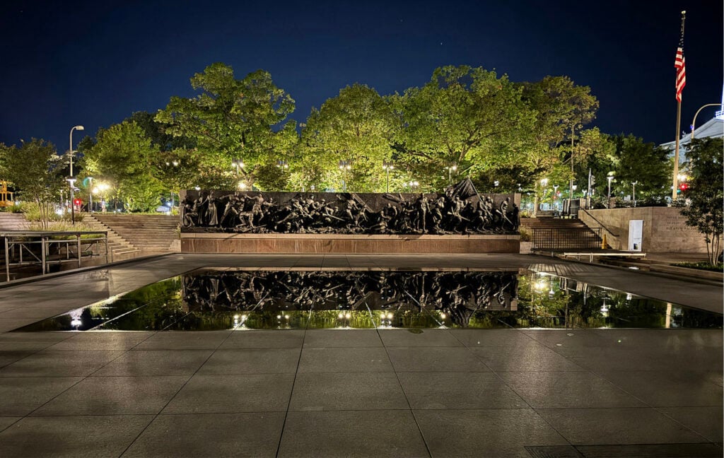 A Journey of Remembrance By David Shiller | The reflecting pool adds a mirrored image of the bronze sculpture, depicting the journey of an American soldier and, by extension, the larger American experience of WWI. Photo: Fisher Marantz Stone