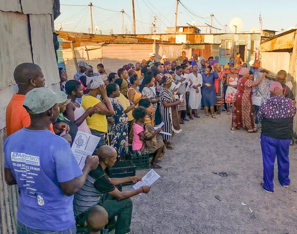 From Darkness to Dignity | Empowering African refugee communities and informal settlements | One of many community meetings held in PJS Informal Settlement, Khayelitsha, that involves residents in the solar lighting project. Photo: Stephanie Briers