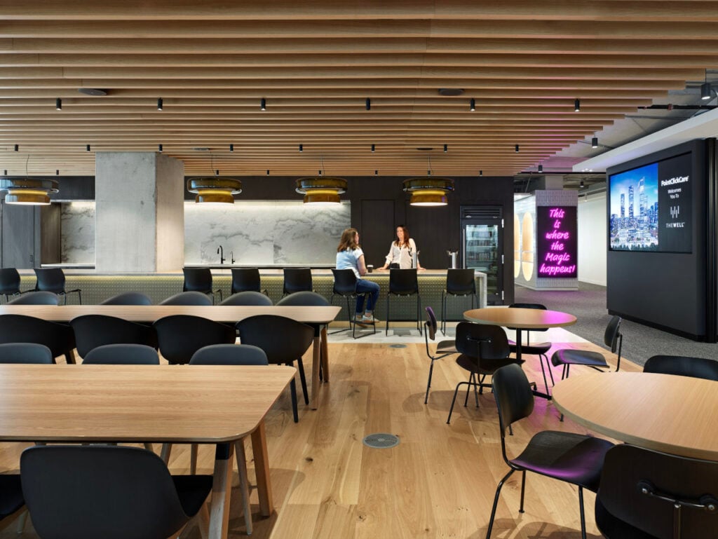 Hospitality in the Workplace 1 Hospitality in the Workplace | The suspended magnetic track system peeks through the slatted ceiling while earth-toned pendants provide a focal point above the servery